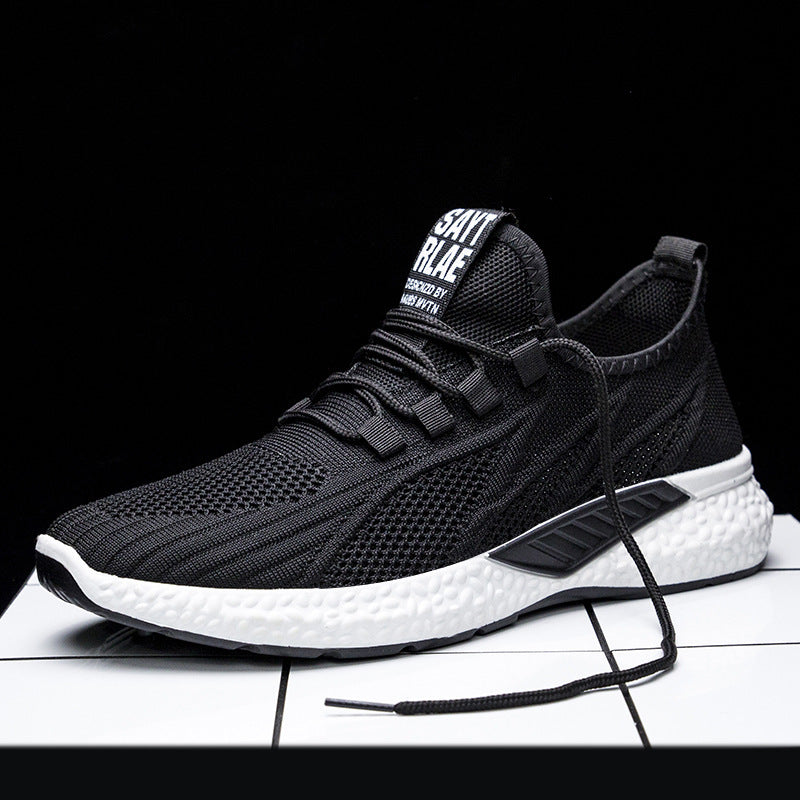 Black running shoe with white sole on a black background