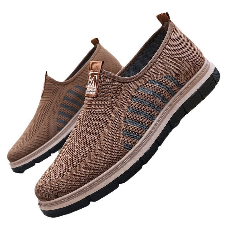 Brown slip-on shoes with black soles on a white background