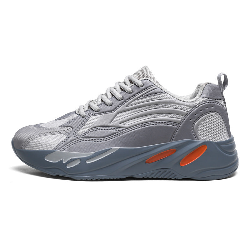 Gray sneaker with orange accents on a white background