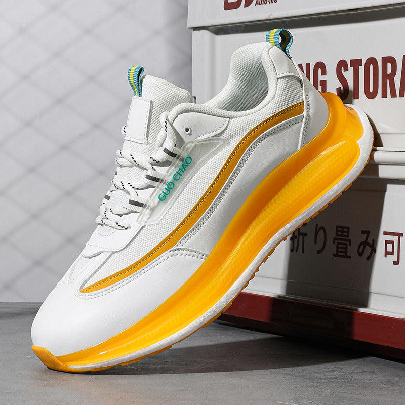 White and yellow sneaker with visible brand logo on a gray background