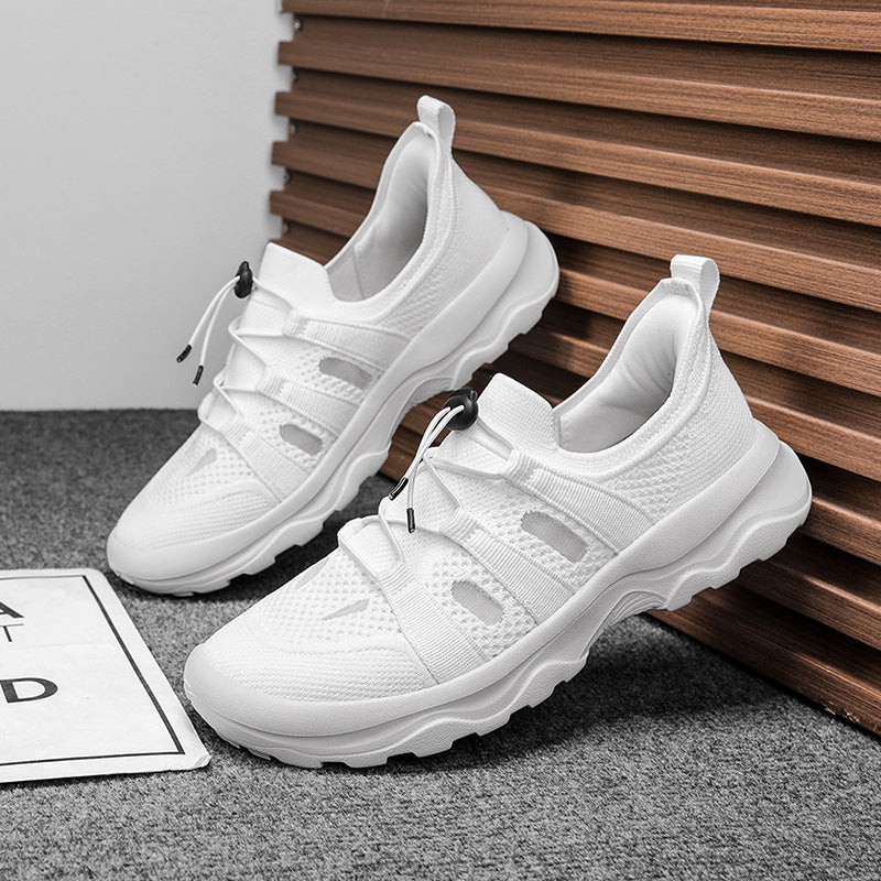 White sneakers on a gray surface with a wooden panel background