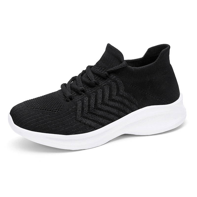 A black knit slip-on sneaker with a thick white sole, shown from a three-quarters angle on a white background.
