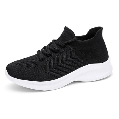 A black knit slip-on sneaker with a thick white sole, shown from a three-quarters angle on a white background.