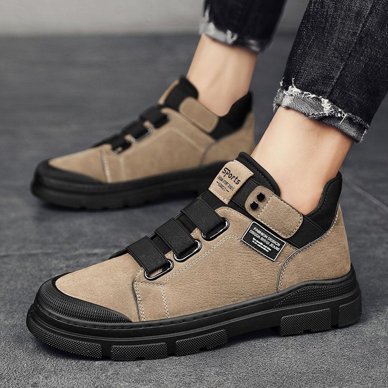 Beige and black shoes with velcro straps on a gray surface