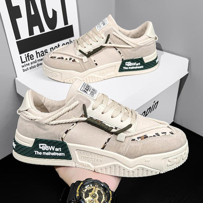 Beige sneakers with green accents on a white box