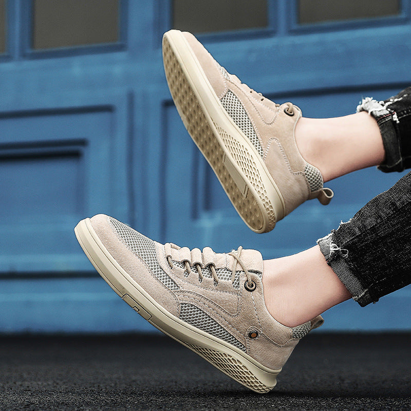 Beige sneakers worn by a person against a blue door background