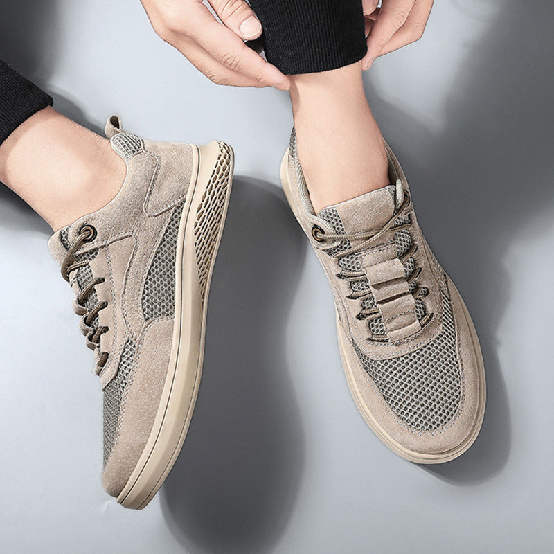 Beige sneakers worn by a person on a light gray background