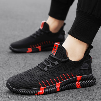 Black and red athletic shoes on a gray surface
