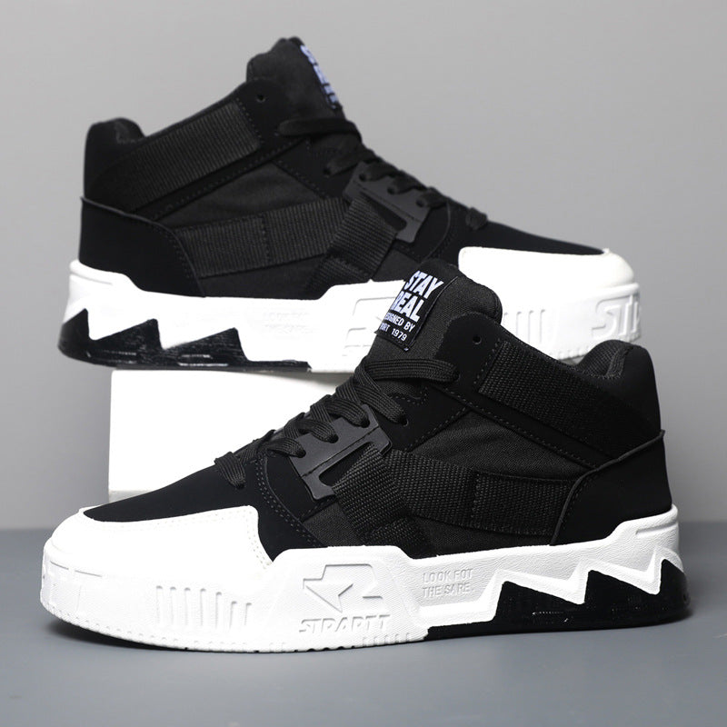 Black and white high-top sneakers on a gray background