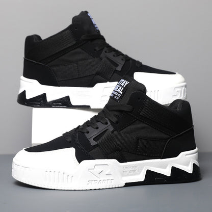 Black and white high-top sneakers on a gray background