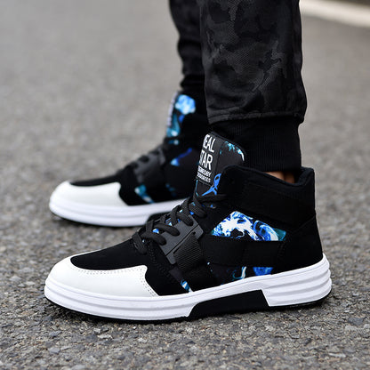 Black and white sneakers with blue designs on a pavement background