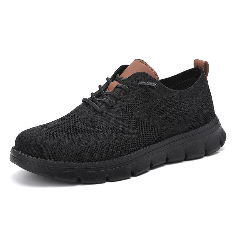 Black athletic shoe with brown accents on a white background