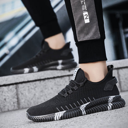 Black athletic shoes worn by a person on a blurred urban background