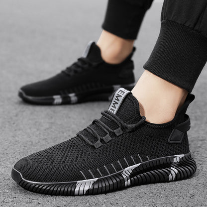 Black athletic shoes worn by a person on a gray surface