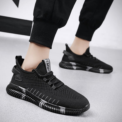 Black athletic shoes worn with black pants on a light gray background