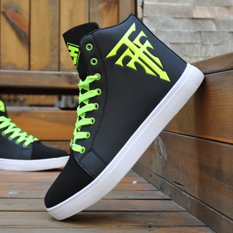Black high-top sneakers with bright green laces and design on a wooden surface.