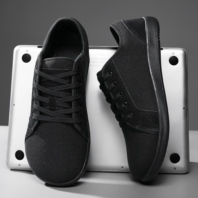 Black sneakers on a metallic surface with a gray background