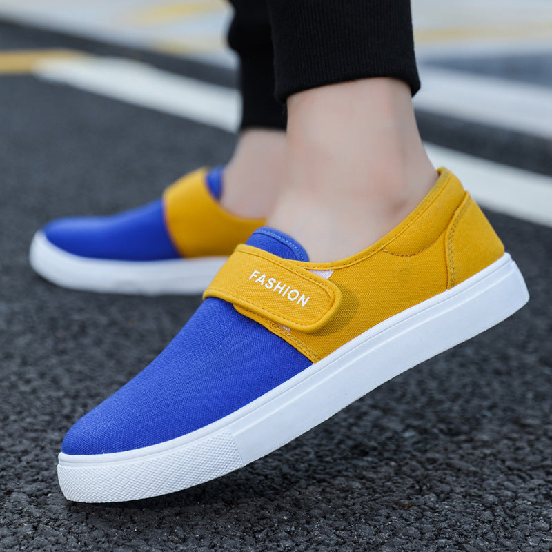 Blue and yellow slip-on shoes with 'Fashion' label on a street background