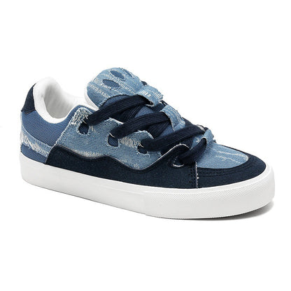Blue denim sneaker with white sole on a white background