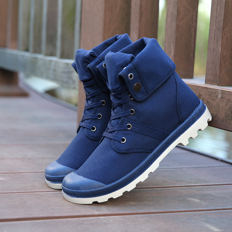 Blue high-top boots with white soles on a wooden floor