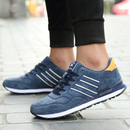 Blue sneakers with white stripes worn on a blurred outdoor background
