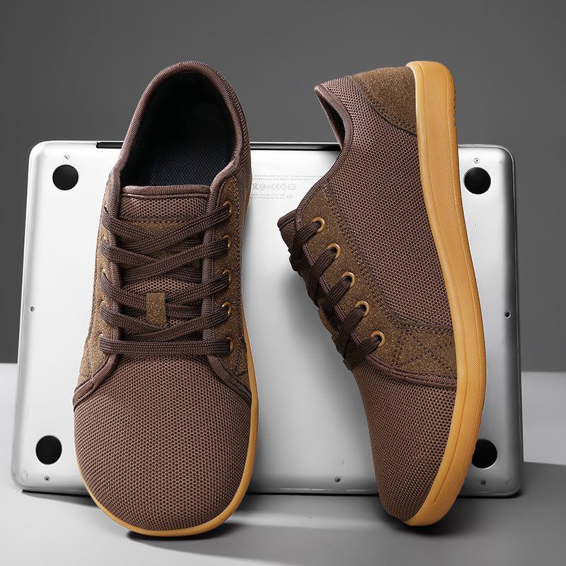 Brown sneakers with tan soles on a gray background