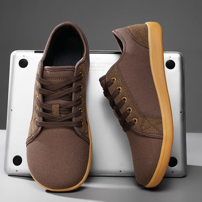 Brown sneakers with tan soles on a gray background