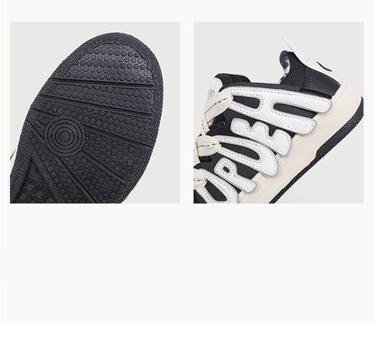 Close-up of a black and white sneaker with textured sole and brand logo.