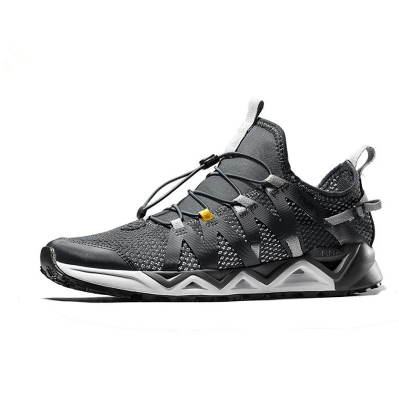 Gray athletic shoe with black accents on a white background