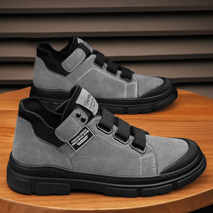 Gray high-top sneakers with black accents on a wooden surface