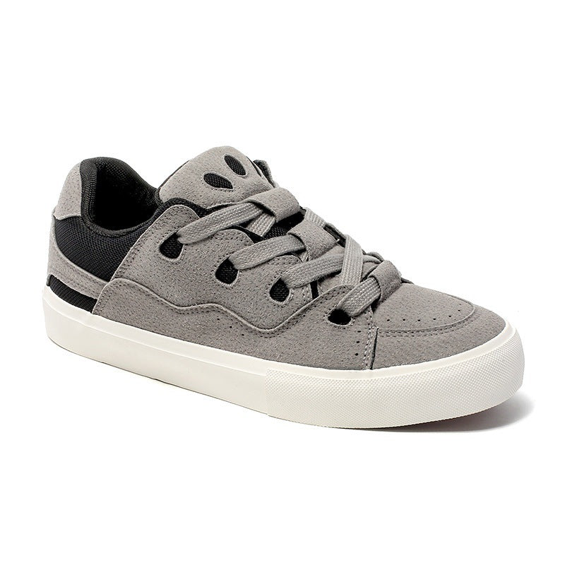 Gray sneaker with black accents on a white background