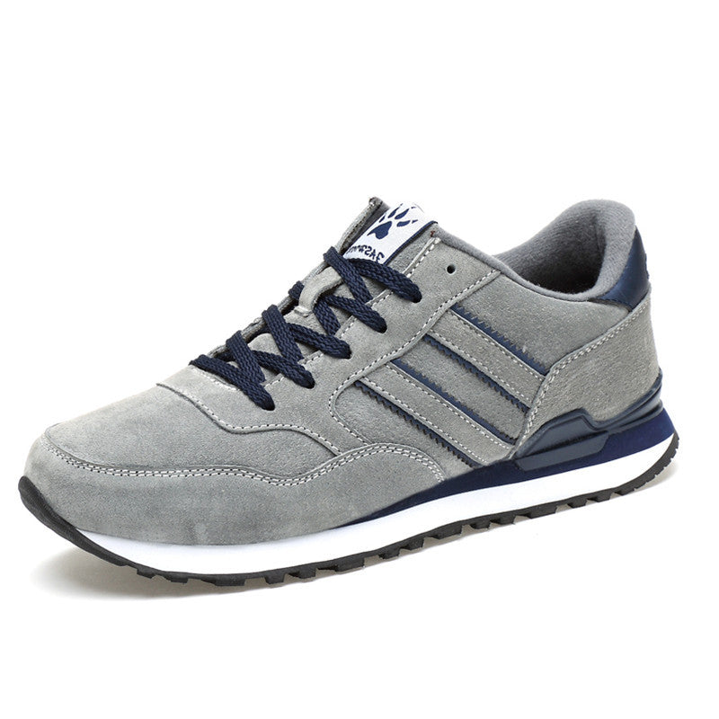 Gray sneaker with navy laces and accents on a white background