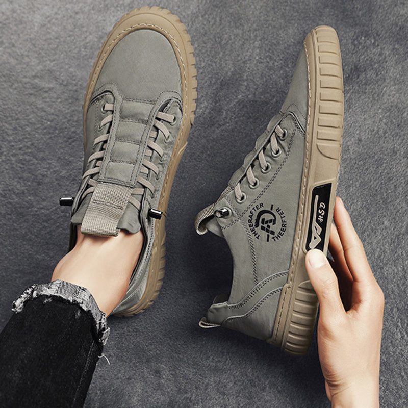 Gray sneakers with brand logo on a dark gray background