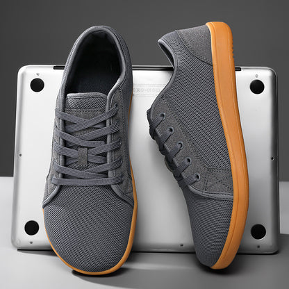 Gray sneakers with brown soles on a metallic surface
