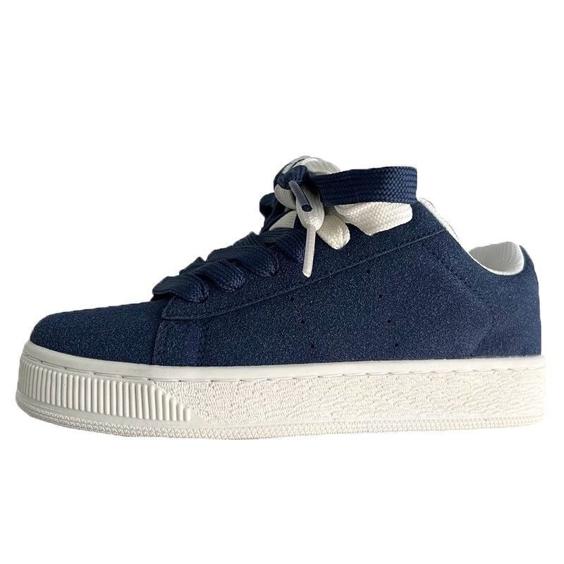Navy blue sneaker with white sole on a white background