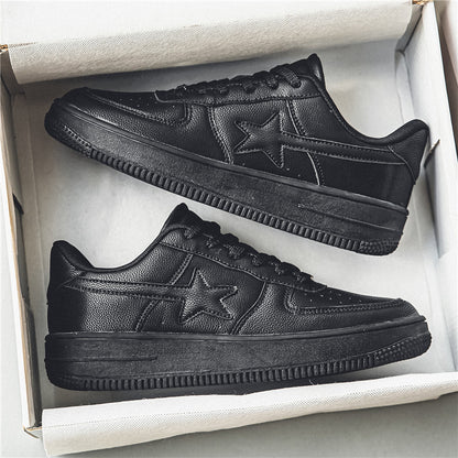 Pair of black sneakers with a star design in a box