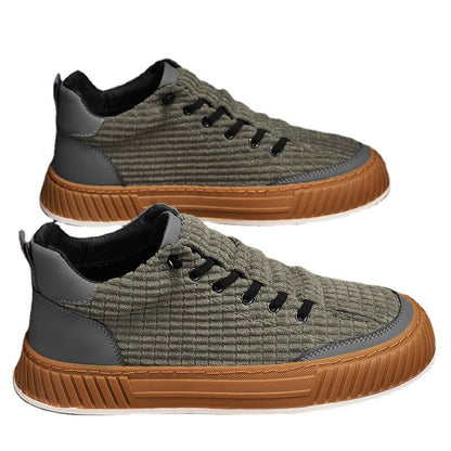 Pair of green sneakers with brown soles on a white background