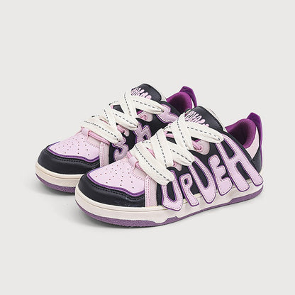 Pair of sneakers with 'True' branding on a light gray background