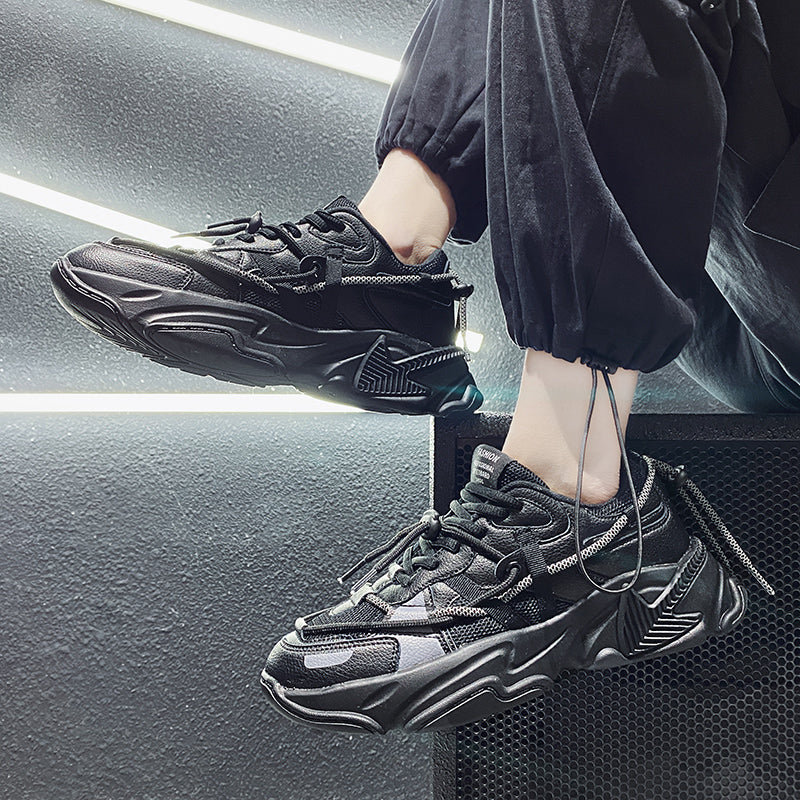 Person wearing black sneakers with a modern interior background