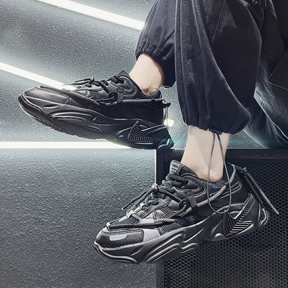 Person wearing black sneakers with a modern interior background