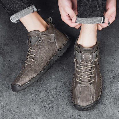 Person wearing brown leather boots on a dark concrete floor