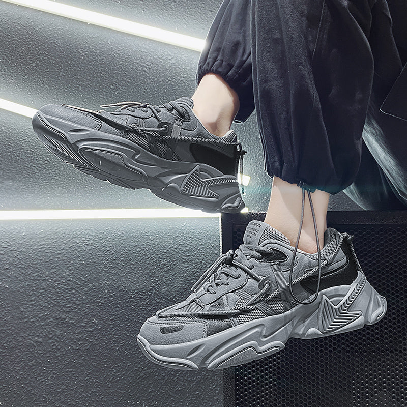 Person wearing gray sneakers with a modern interior background