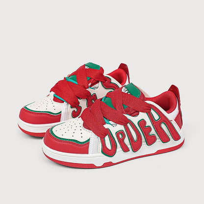 Red and white sneakers with green accents on a light gray background