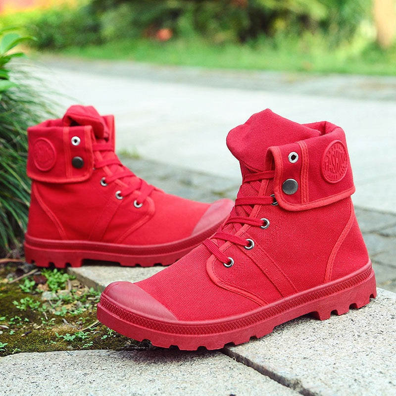 Red high-top boots on a stone surface with greenery in the background