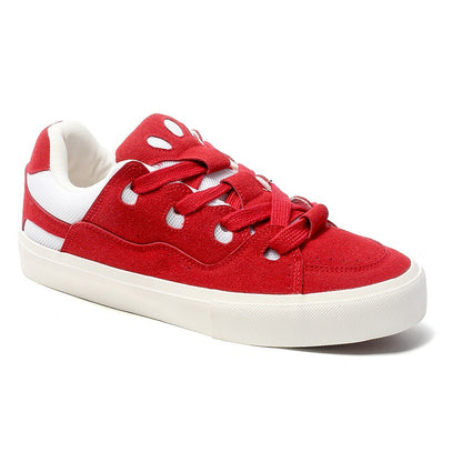 Red sneaker with white laces and sole on a white background