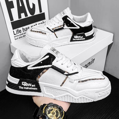 White and black sneakers with brand logos on a black surface, with a watch visible.
