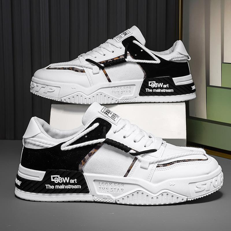 White and black sneakers with visible branding on a gray surface.
