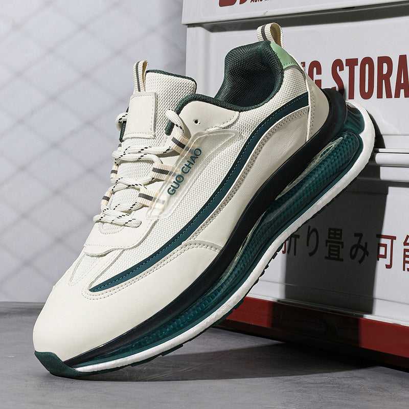 White and green sneaker with brand logo on a gray surface