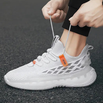 White athletic shoe with orange tag being tied by a person on a dark background