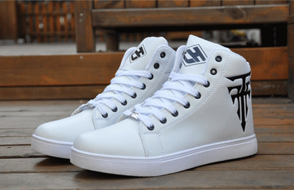 White high-top sneakers with a logo on a wooden floor